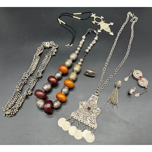 84 - Collection of Middel east jewellery to include amber and white metal necklace, White metal filigree ... 