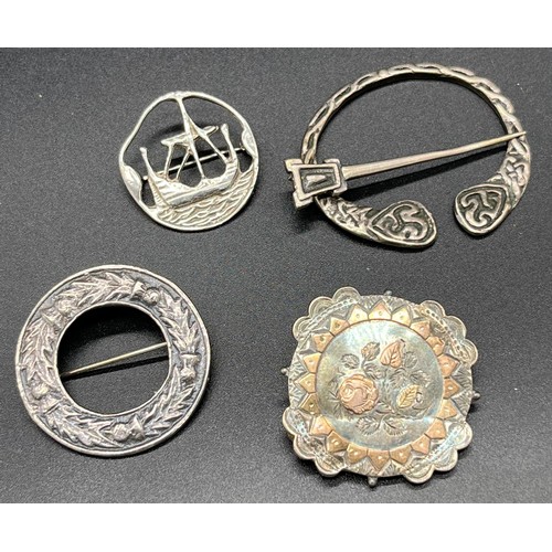 88 - Four various silver brooches. Includes Celtic plaid brooch, Edinburgh silver long boat brooch by Ton... 