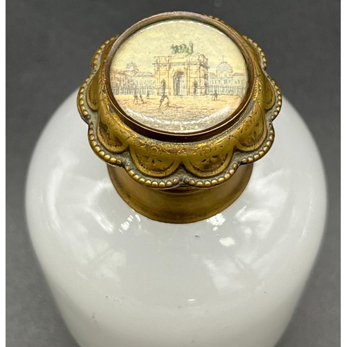 96 - 19th century white glass perfume bottle, designed with a gilt metal lid depicting a small picture of... 