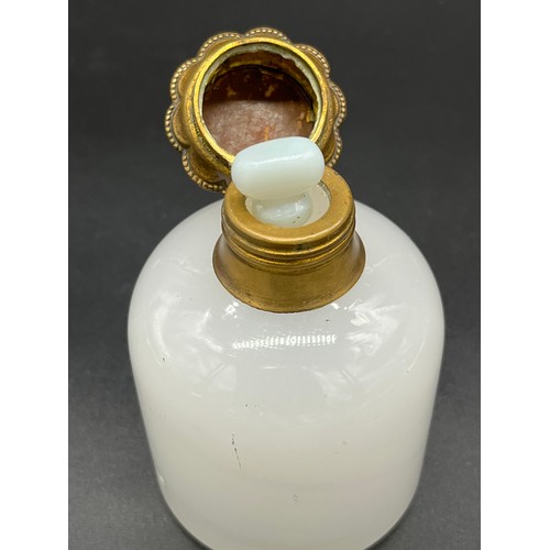 96 - 19th century white glass perfume bottle, designed with a gilt metal lid depicting a small picture of... 