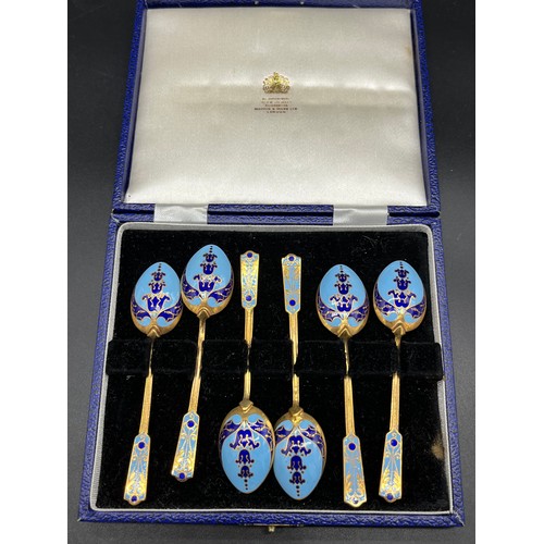 132 - Boxed set of six gilt metal and enamelled tea spoons.