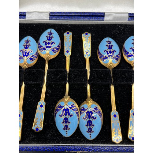 132 - Boxed set of six gilt metal and enamelled tea spoons.