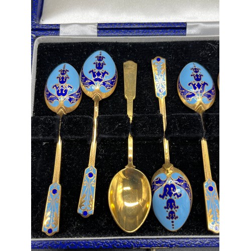 132 - Boxed set of six gilt metal and enamelled tea spoons.