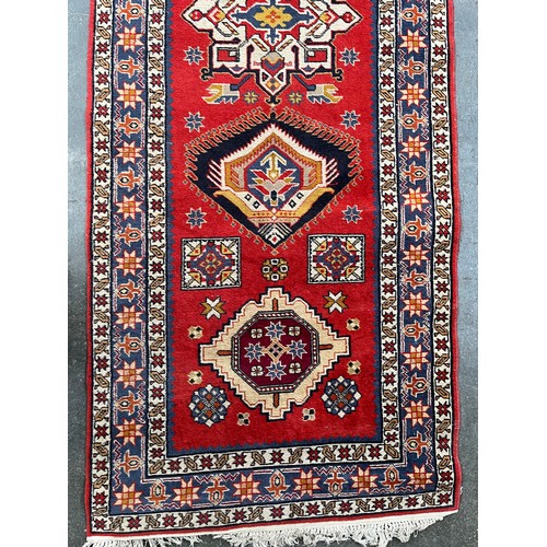 154 - Persian style woven rug. Red ground. [150x98cm]