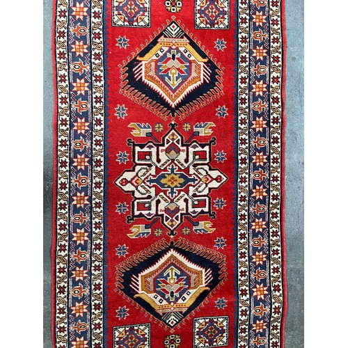 154 - Persian style woven rug. Red ground. [150x98cm]