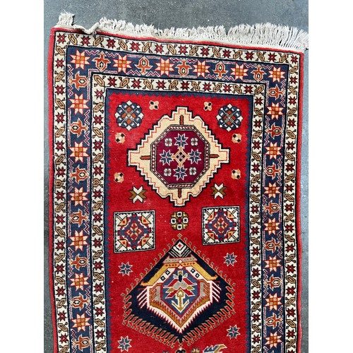 154 - Persian style woven rug. Red ground. [150x98cm]