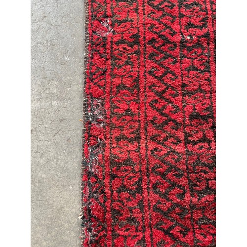 161 - Antique hand woven Indian/ Persian red and black ground rug. [193x120cm]