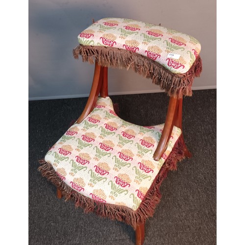 350 - 19th century prayer stool/ chair, upholstered in a floral material with brown fringe, raised on outs... 