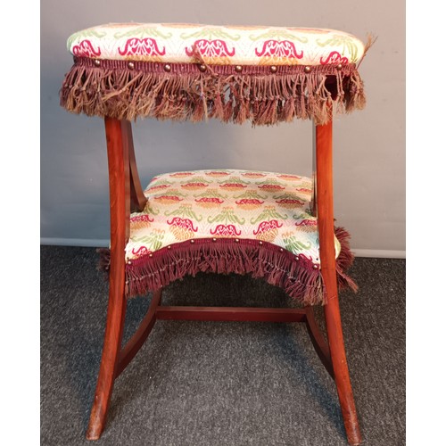 350 - 19th century prayer stool/ chair, upholstered in a floral material with brown fringe, raised on outs... 