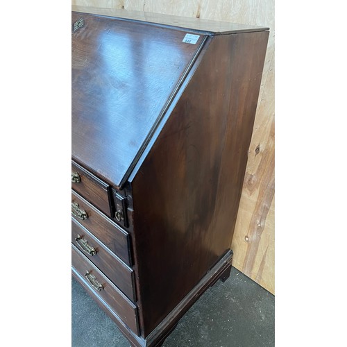 415 - Georgian writing bureau, the sloped top opening to a writing surface with storage compartments, abov... 