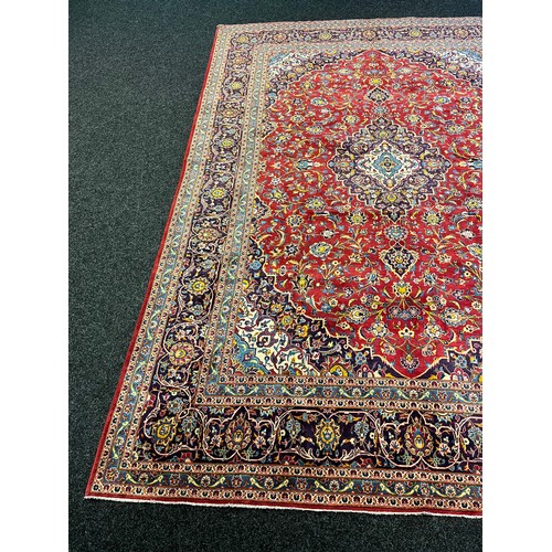 365 - Large Persian carpet/rug, highly decorative with red ground.  [535x296cm]