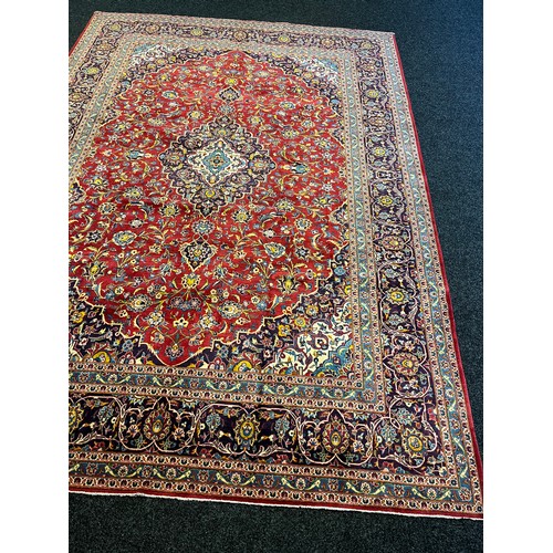 365 - Large Persian carpet/rug, highly decorative with red ground.  [535x296cm]