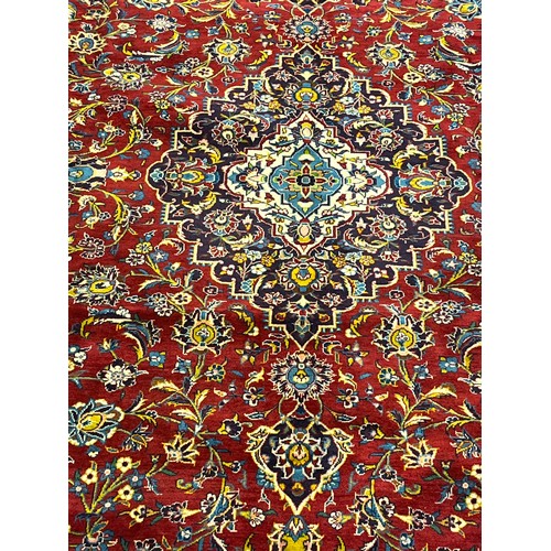 365 - Large Persian carpet/rug, highly decorative with red ground.  [535x296cm]