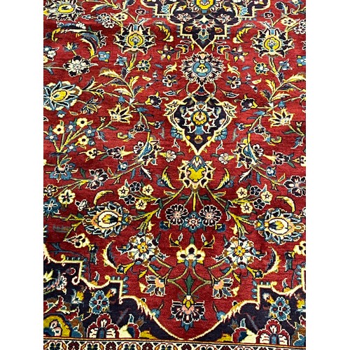 365 - Large Persian carpet/rug, highly decorative with red ground.  [535x296cm]