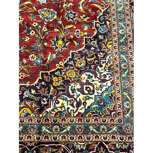 365 - Large Persian carpet/rug, highly decorative with red ground.  [535x296cm]