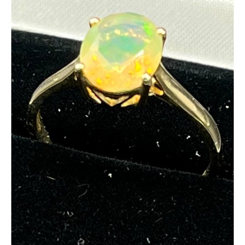 216 - 10ct yellow gold ladies ring set with a single opalescent style stone ring. [Ring size R] [2.14Grams... 