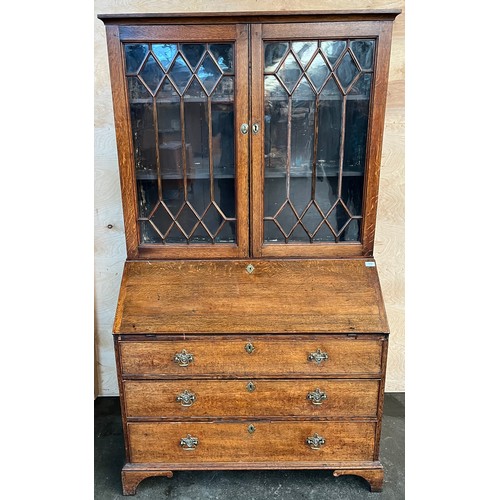 312 - 19th century bureau bookcase, the top with glass doors with a moulded wooden design to the panels, o... 