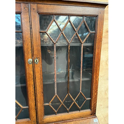 312 - 19th century bureau bookcase, the top with glass doors with a moulded wooden design to the panels, o... 