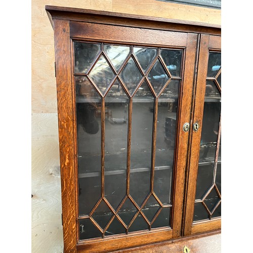 312 - 19th century bureau bookcase, the top with glass doors with a moulded wooden design to the panels, o... 