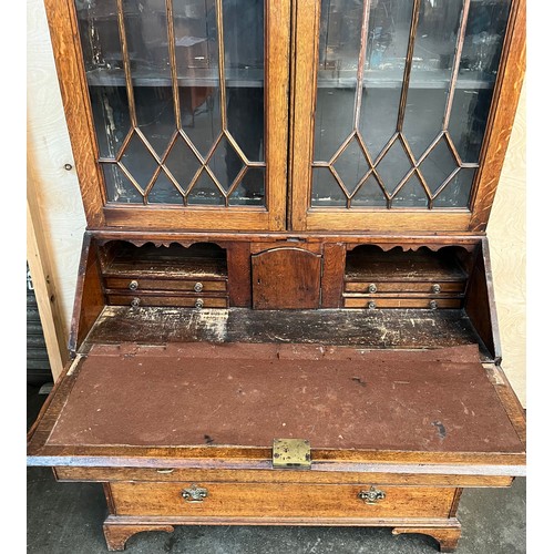 312 - 19th century bureau bookcase, the top with glass doors with a moulded wooden design to the panels, o... 