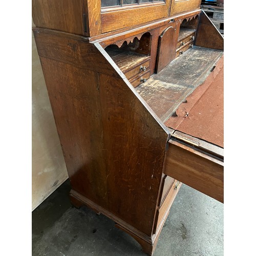 312 - 19th century bureau bookcase, the top with glass doors with a moulded wooden design to the panels, o... 