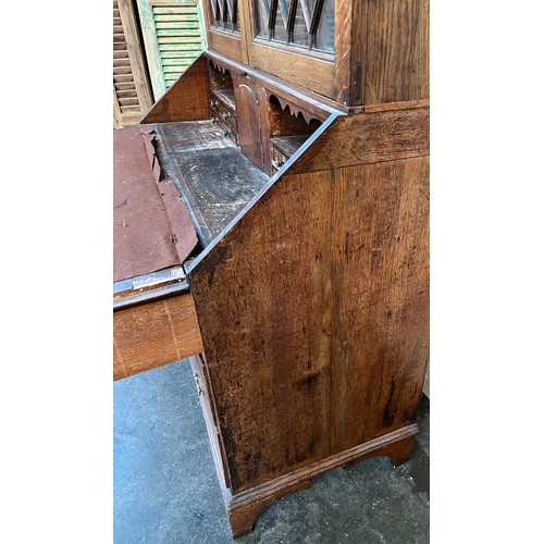 312 - 19th century bureau bookcase, the top with glass doors with a moulded wooden design to the panels, o... 