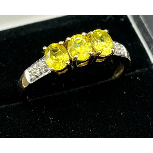 38 - 9ct yellow gold ladies ring set with three green tourmaline stones off set with diamond shoulders. [... 