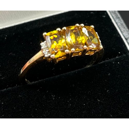 39 - 10ct yellow gold ladies ring set with three yellow tourmaline stones off set by diamond shoulders. [... 