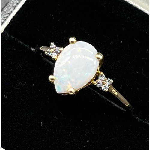 60 - 9ct yellow gold ladies ring set with pear cut opalescent style stone off set by diamond shoulders. [... 