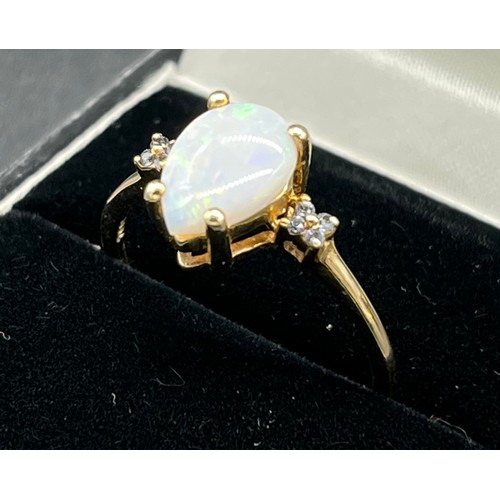 60 - 9ct yellow gold ladies ring set with pear cut opalescent style stone off set by diamond shoulders. [... 