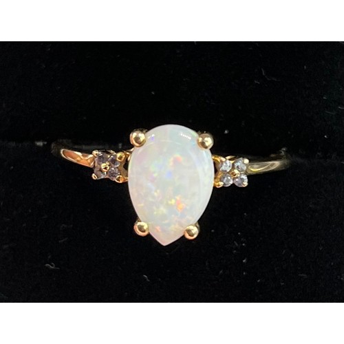 60 - 9ct yellow gold ladies ring set with pear cut opalescent style stone off set by diamond shoulders. [... 