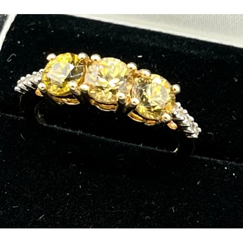 66 - 10ct yellow gold ladies ring set with three yellow stones off set by white spinel stone shoulders. [... 