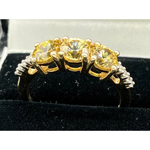 66 - 10ct yellow gold ladies ring set with three yellow stones off set by white spinel stone shoulders. [... 