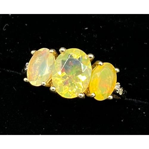 75 - 10ct yellow gold ladies ring set with three opalescent style stones. [Ring size R] [2.66Grams]