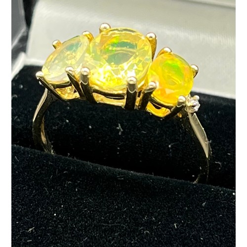 75 - 10ct yellow gold ladies ring set with three opalescent style stones. [Ring size R] [2.66Grams]