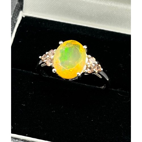 91 - 9ct white gold ladies ring set with a large opalescent style stone off set by pink quartz shoulders.... 