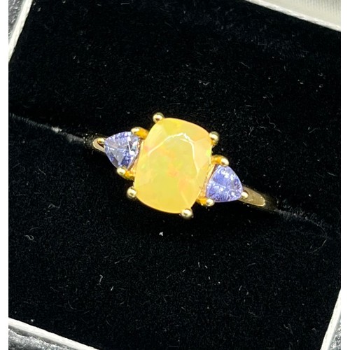 96 - 10ct yellow gold ladies ring set with an opalescent style stone off set by purple tourmaline stone s... 