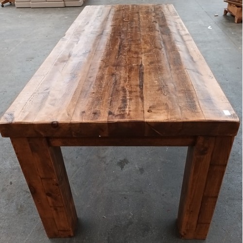 348 - Solid rustic wood dining table, the long rectangular surface raised on square block legs [80x244x97c... 