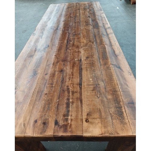 348 - Solid rustic wood dining table, the long rectangular surface raised on square block legs [80x244x97c... 