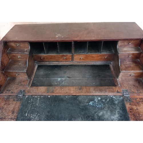 379 - Early 18th century walnut veneer writing bureau, the drop downslope opening to interior storage and ... 