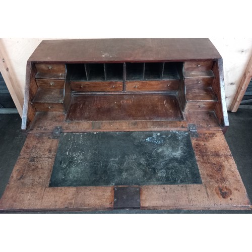 379 - Early 18th century walnut veneer writing bureau, the drop downslope opening to interior storage and ... 