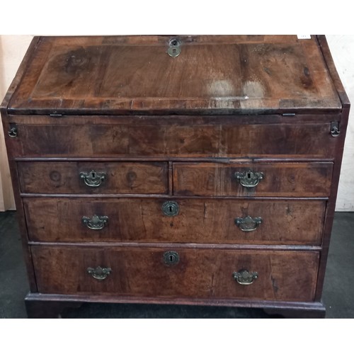 379 - Early 18th century walnut veneer writing bureau, the drop downslope opening to interior storage and ... 