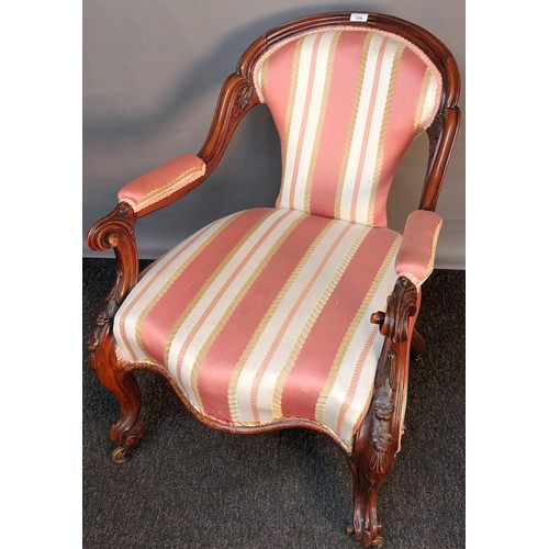 358 - Victorian bedroom armchair, the shaped back above open arm carved scroll supports and a cushioned se... 