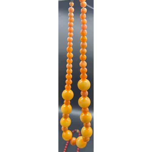 89 - Three vintage necklaces to include coral necklace, glass ball effect necklace and cherry amber style... 