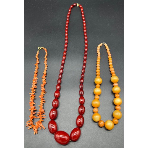 89 - Three vintage necklaces to include coral necklace, glass ball effect necklace and cherry amber style... 