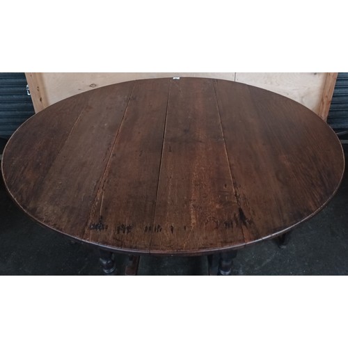 382 - Antique oak table, the oval surface with drop ends, raised on bobble and block legs [78x118x140cm no... 