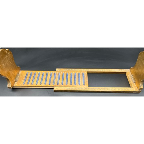 136 - A Regency style moulded and gilt painted table top book shelf.