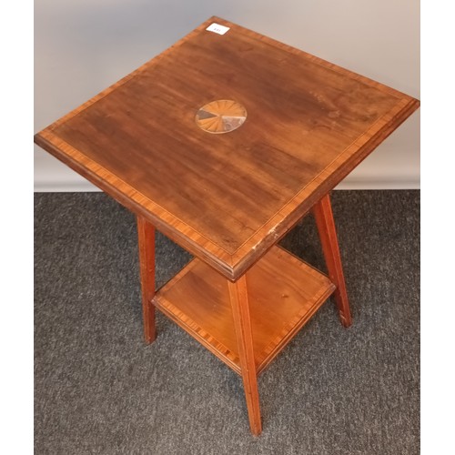 384 - Edwardian two tier window table, the square top with parquetry inlay, above an opposing shelf, raise... 