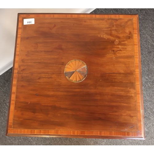 384 - Edwardian two tier window table, the square top with parquetry inlay, above an opposing shelf, raise... 