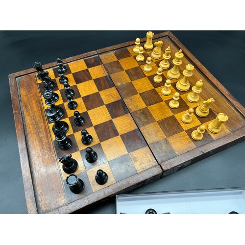 141 - Antique folding chess and back gammon board together with chess pieces.